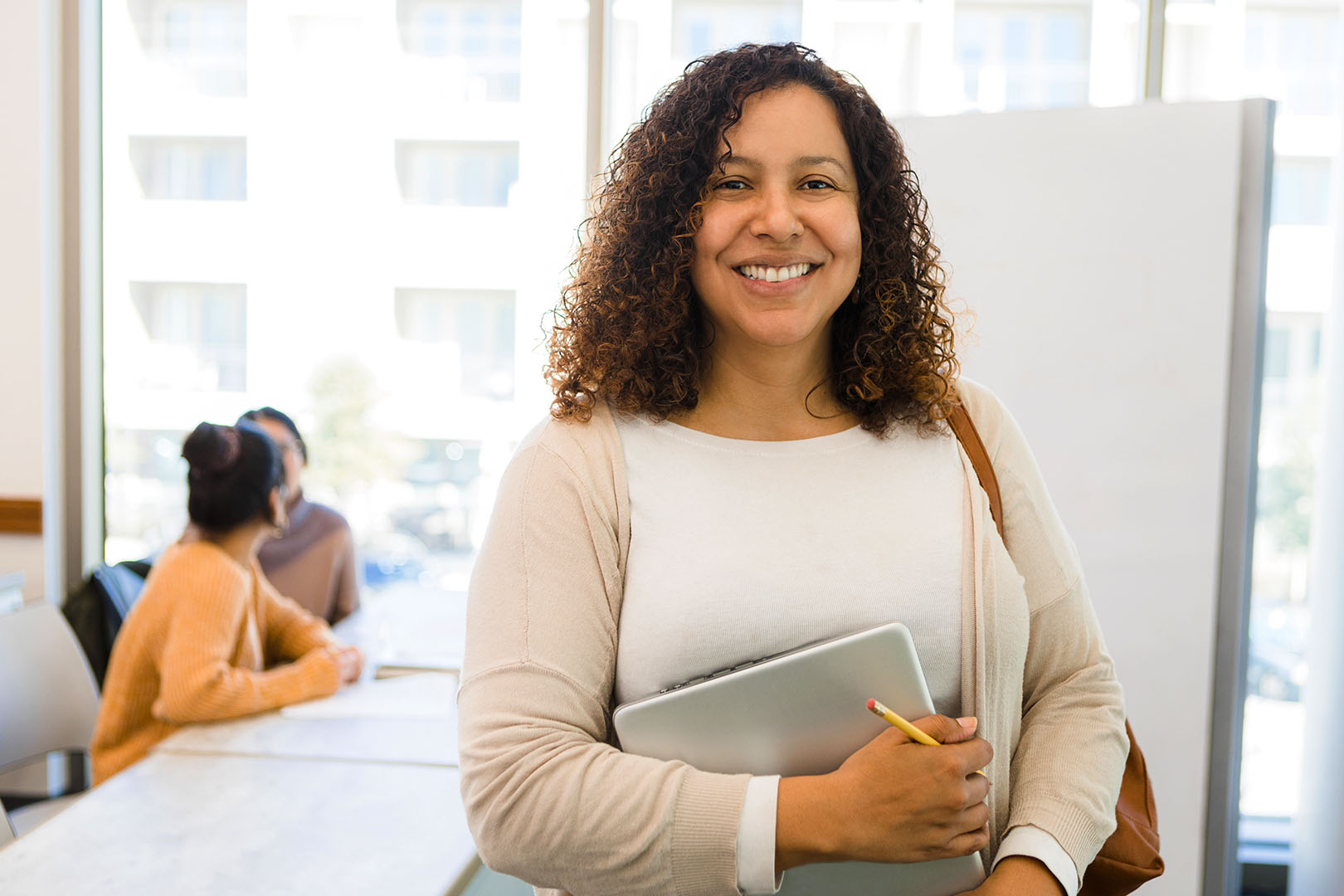 A woman smiling in a classroom