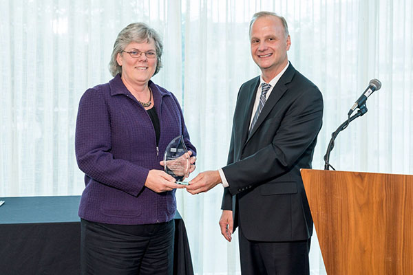Burney receives the R. Lee Brummet Award for Educators from Dr. Raef Lawson.