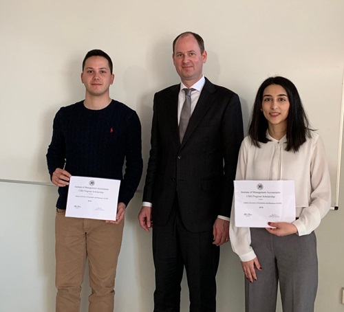 Alain Mulder, center, presents CMA Scholarship awards to two students from Athens University of Economics and Business, which is currently being considered for endorsement under IMA?s Higher Education Endorsement Program.