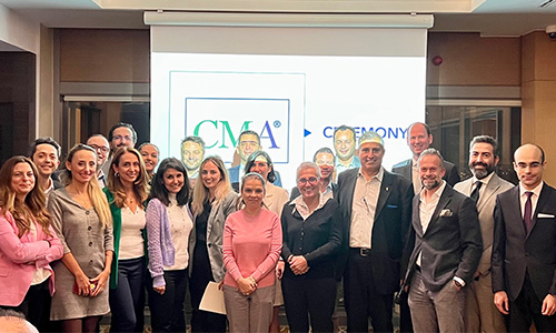 A group in front of a CMA banner at the Turkey chapter event