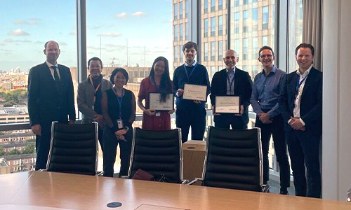 A group of people standing in a conference room in Amsterdam