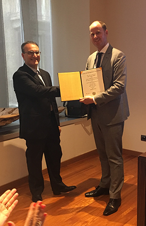 Alain Mulder, right, presents the official chapter charter to De Luca, president of the IMA Italy Chapter.