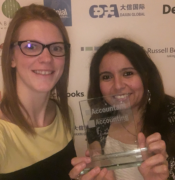 Gilbert (l.) and El-Wakeel (r.) proudly show off the award.