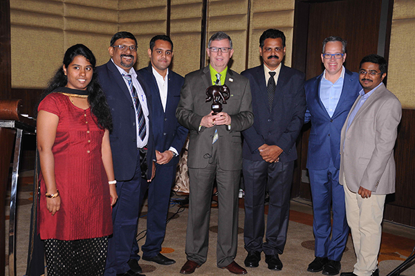 Thomson accepts a token of appreciation from board members of the IMA Chennai Chapter.