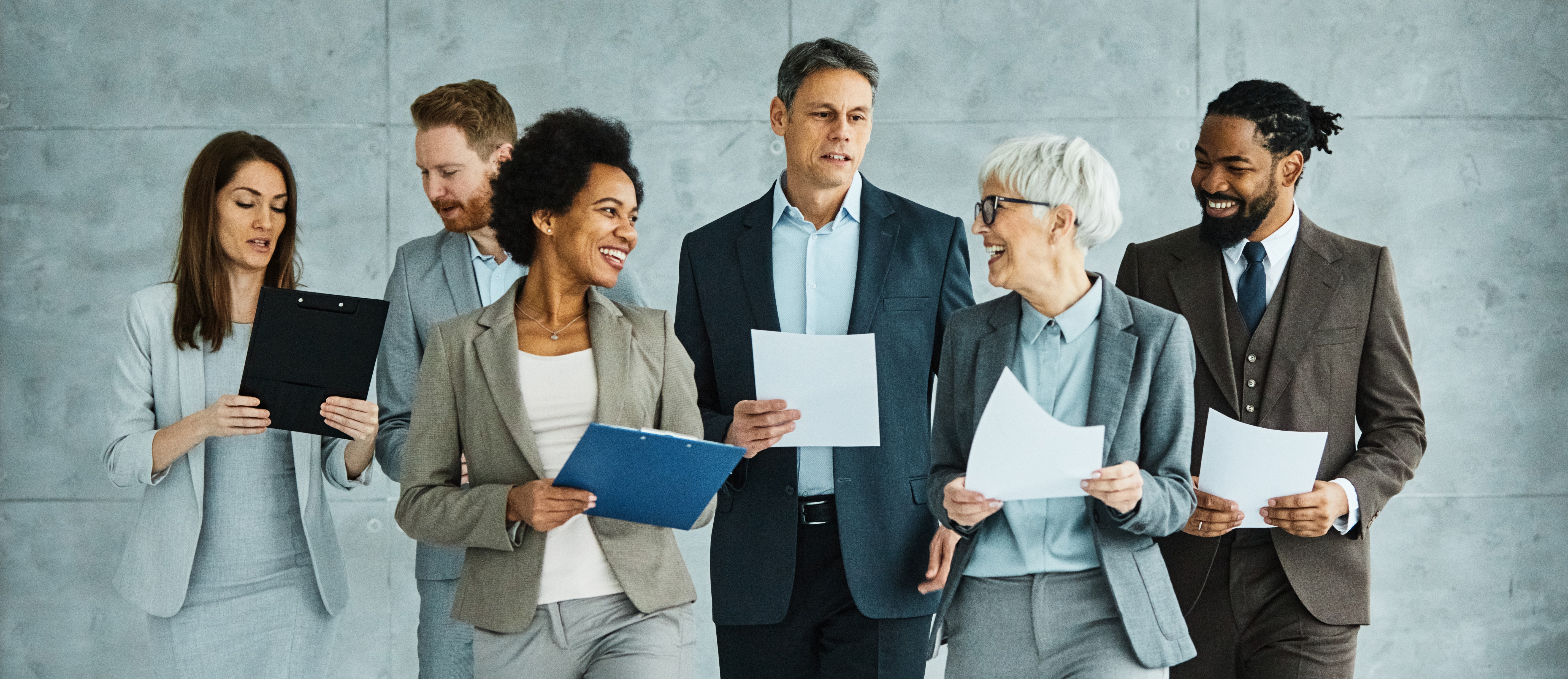 A group of people holding paperwork