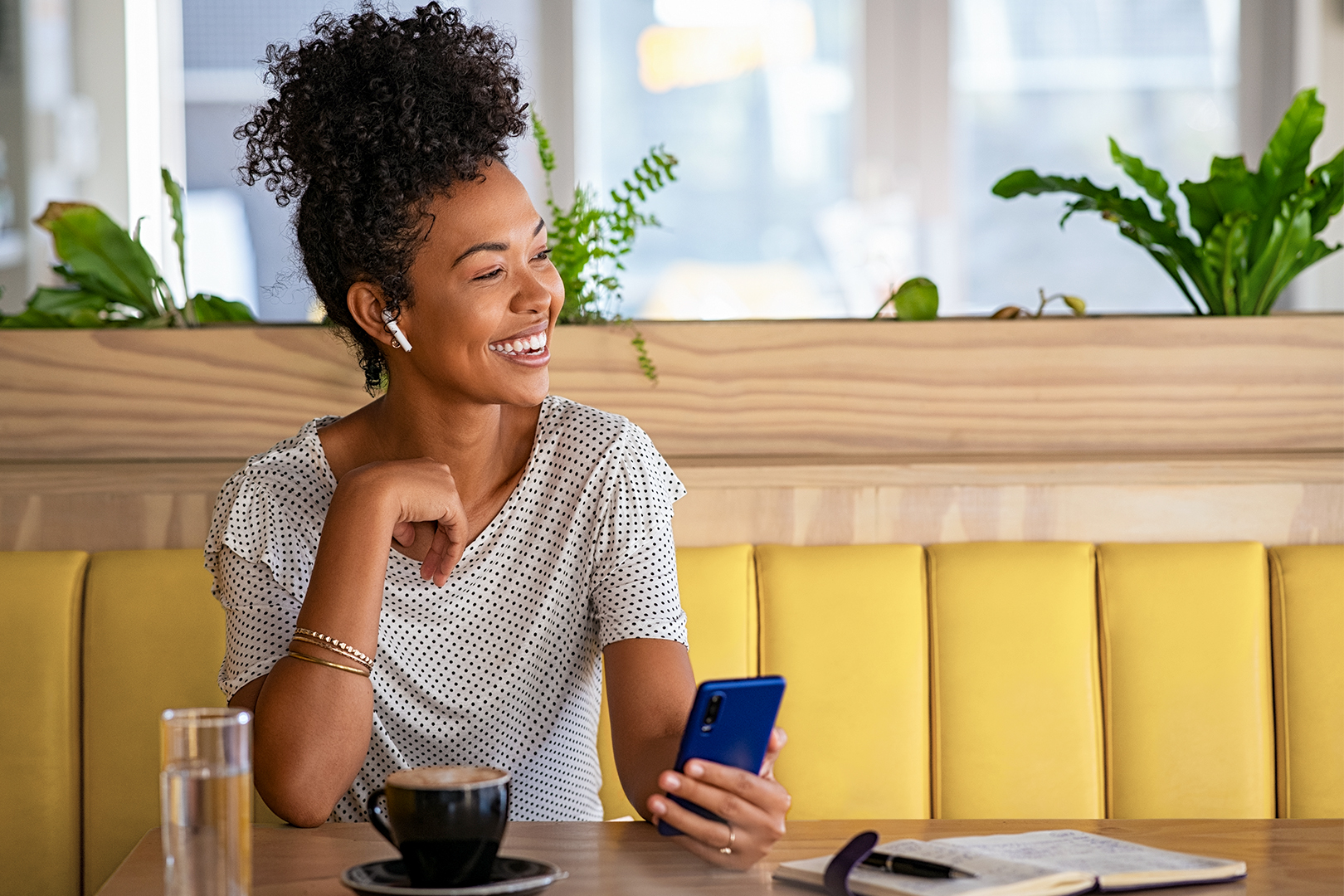 A woman smiling as she talks on the phone