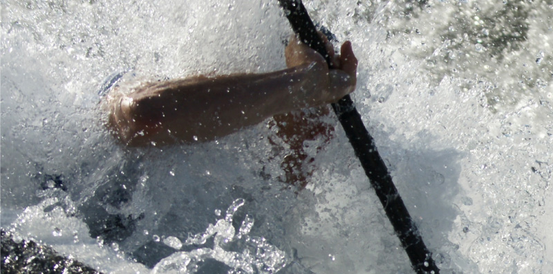 A person navigating river rapids