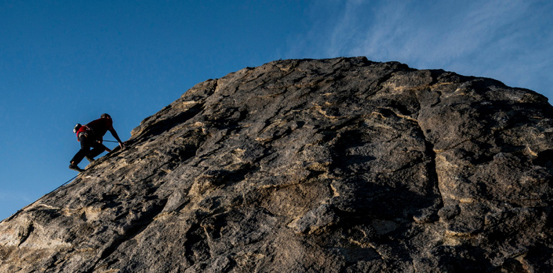 A person climbing mountain