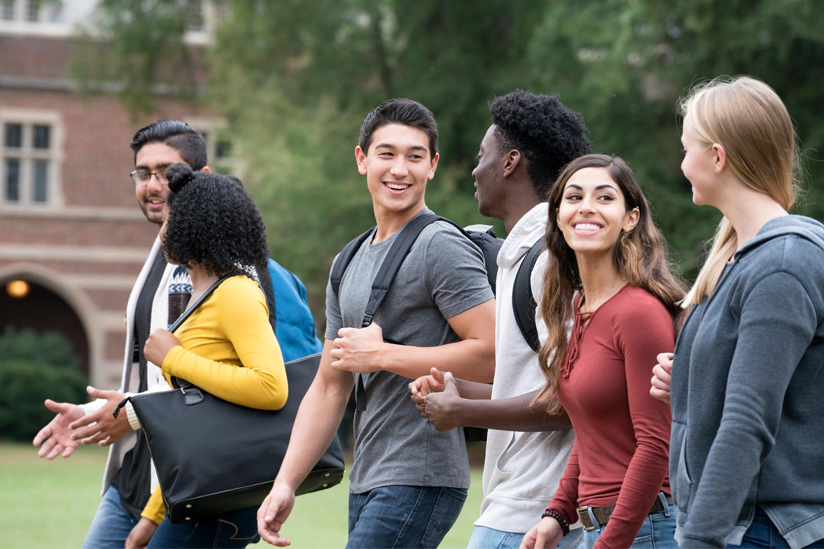 Students walking and smiling on a college campus