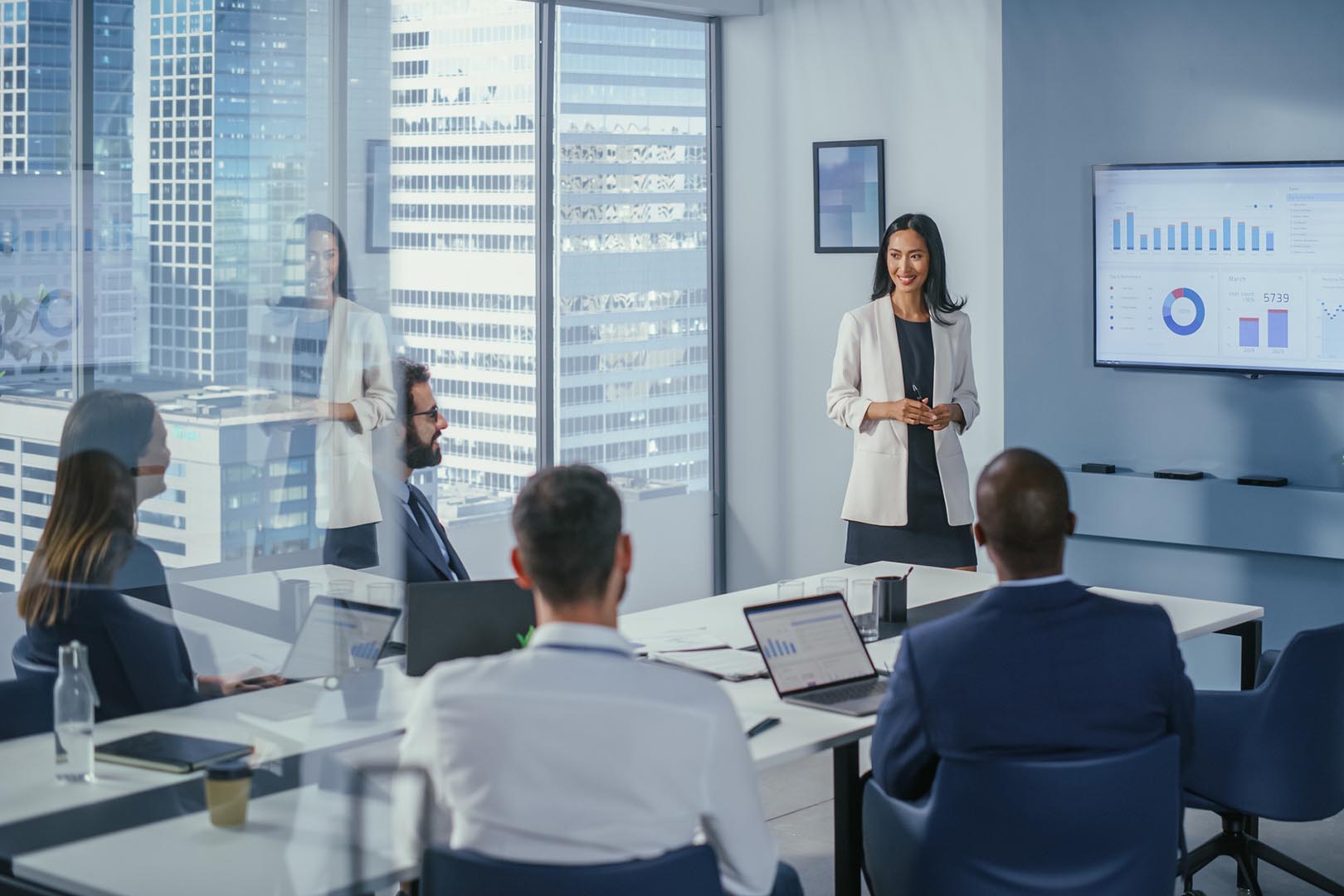 Woman presenting to a team in a conference room