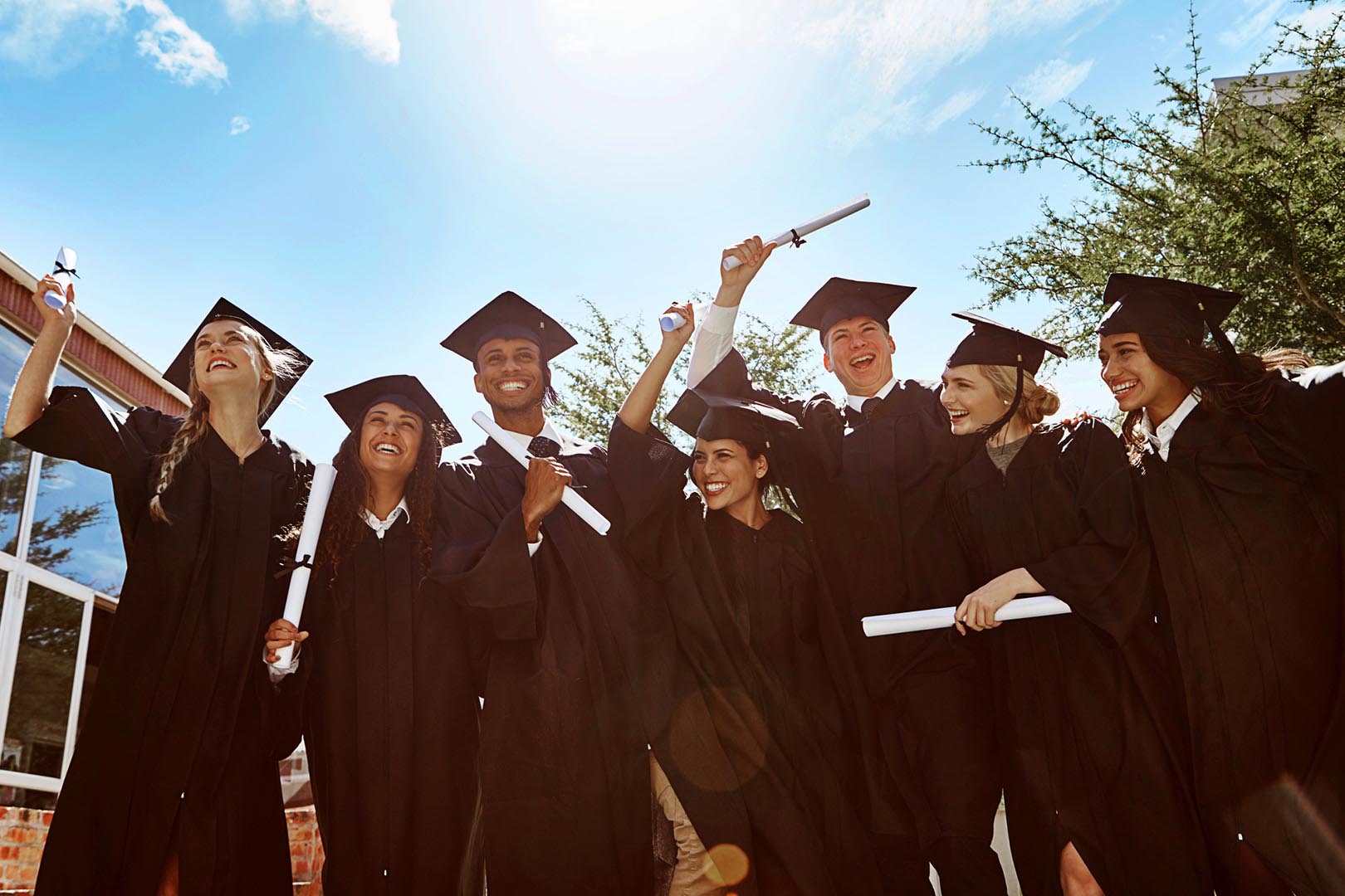 Diverse group of happy students graduating