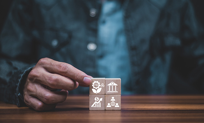 men holding blocks with icons
