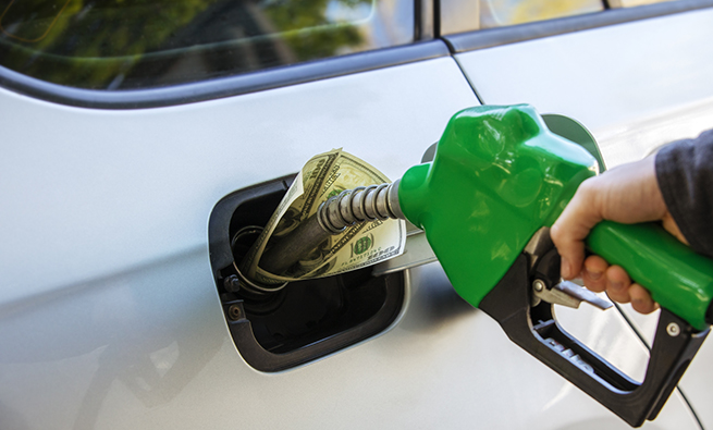 a person fueling the car