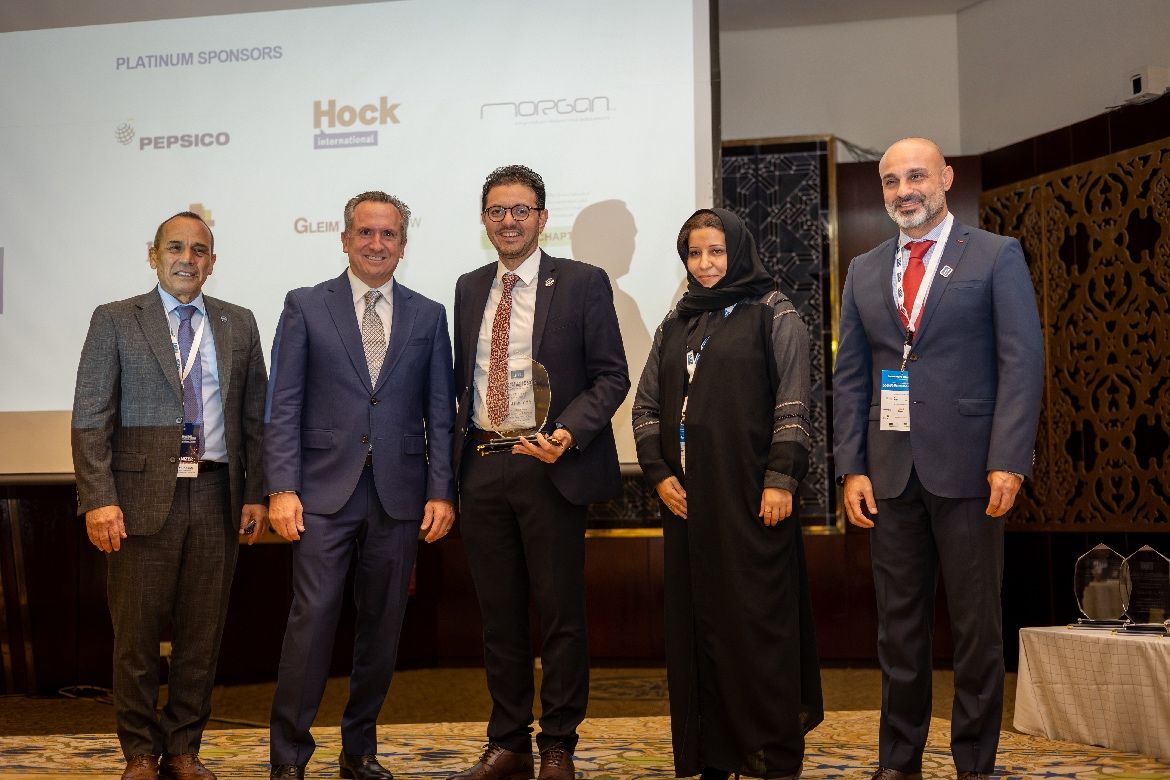 Mike Deprisco standing with attendees at the Middle East Regional Conference