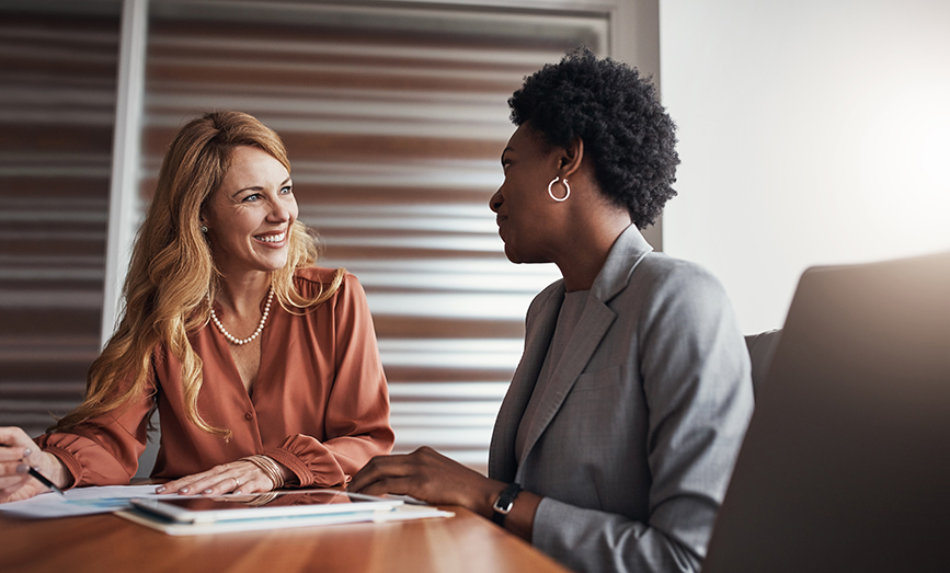 women sitting at a table smiling